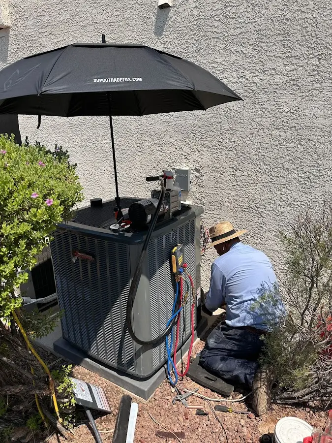 HVAC technician performing outdoor AC maintenance in Waukegan